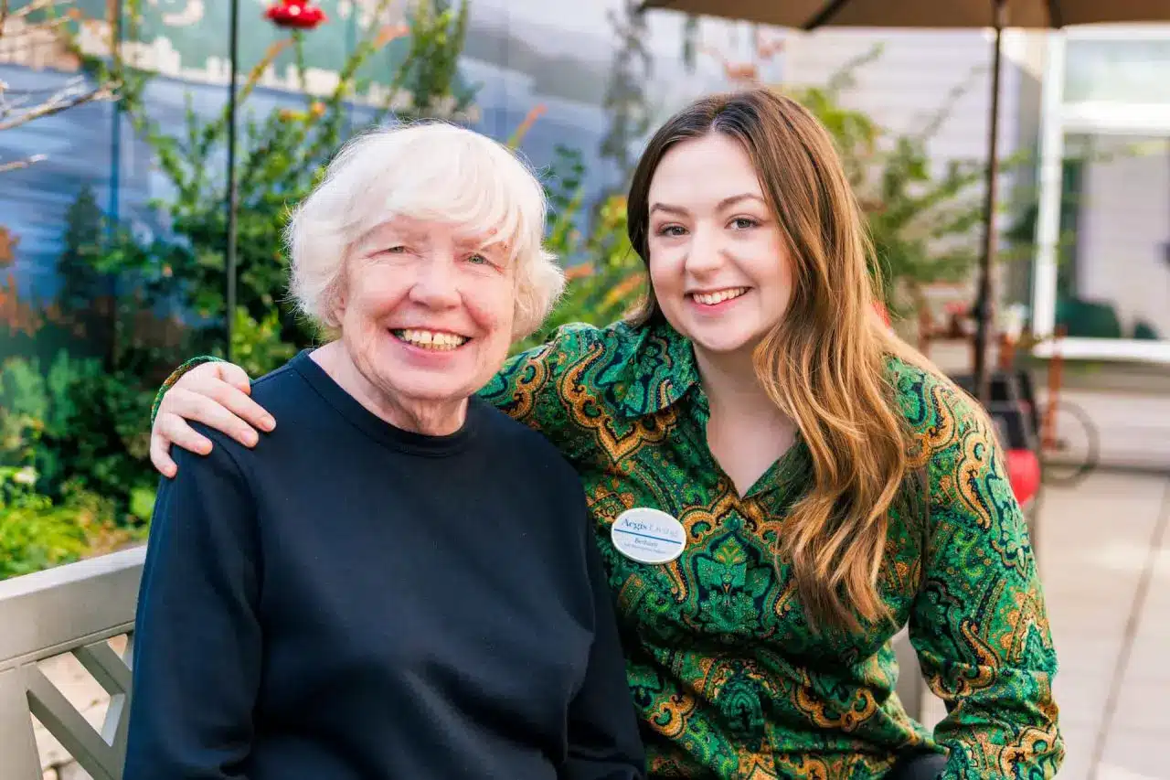 Senior smiling with an Aegis Living caregiver