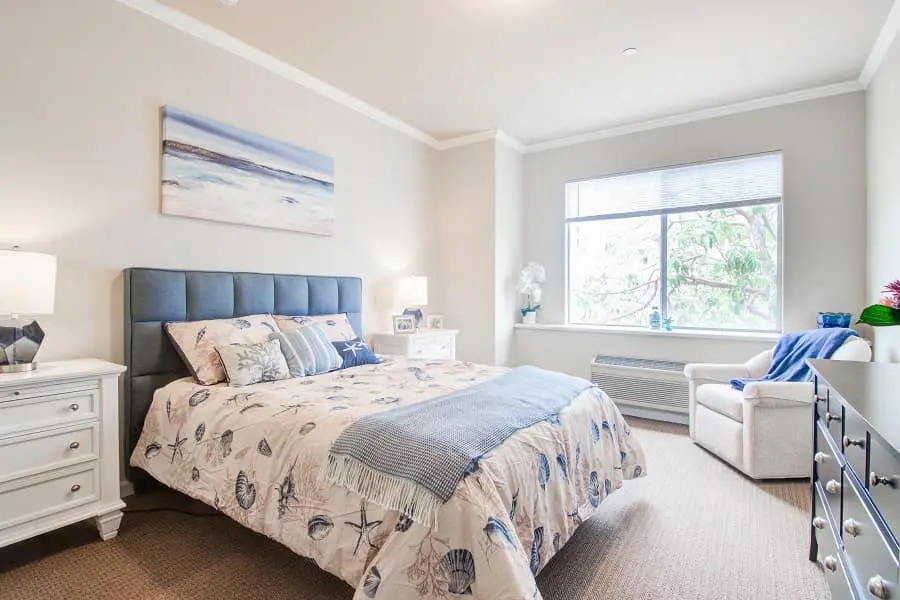 A coastal themed bedroom inside of an Aegis Living facility