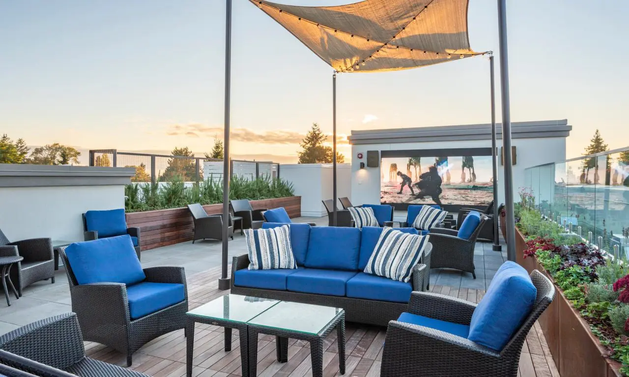 An outdoor lounge area featuring a large movie screen