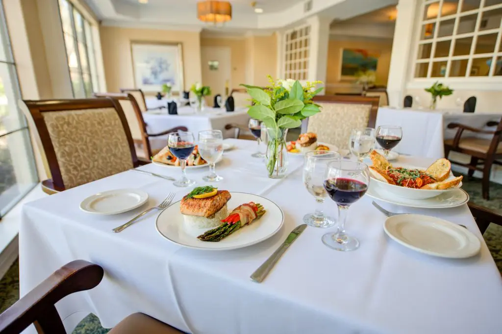 Elegant dining table with gourmet dishes and wine.
